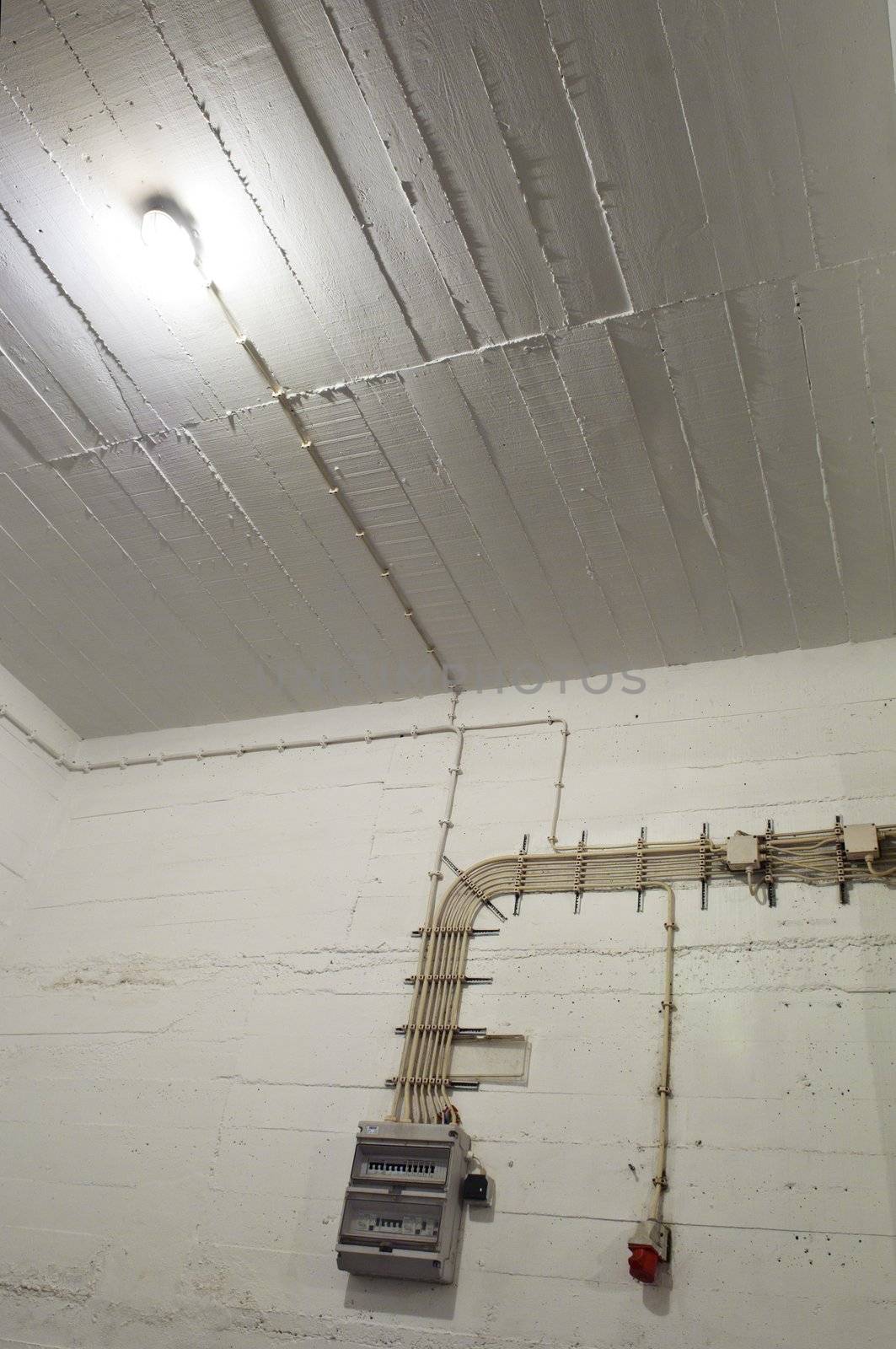 Industrial basement wall with wiring and breaker box