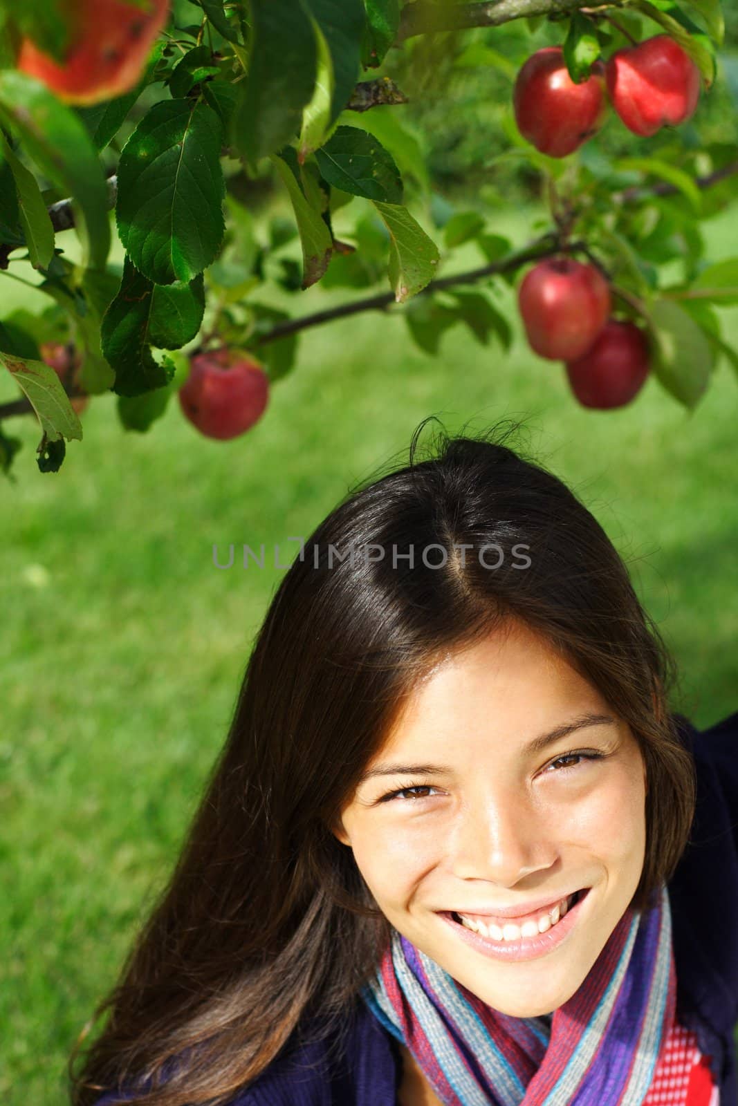 Autumn woman under apple tree