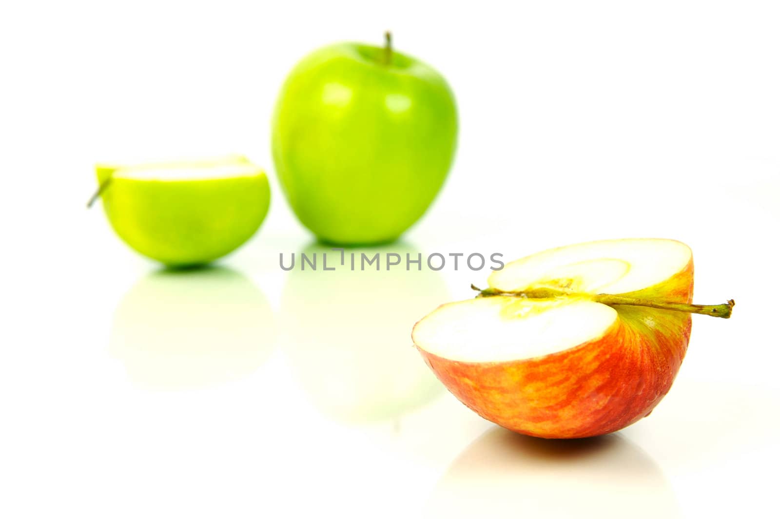 Red and green apples isolated against a white background