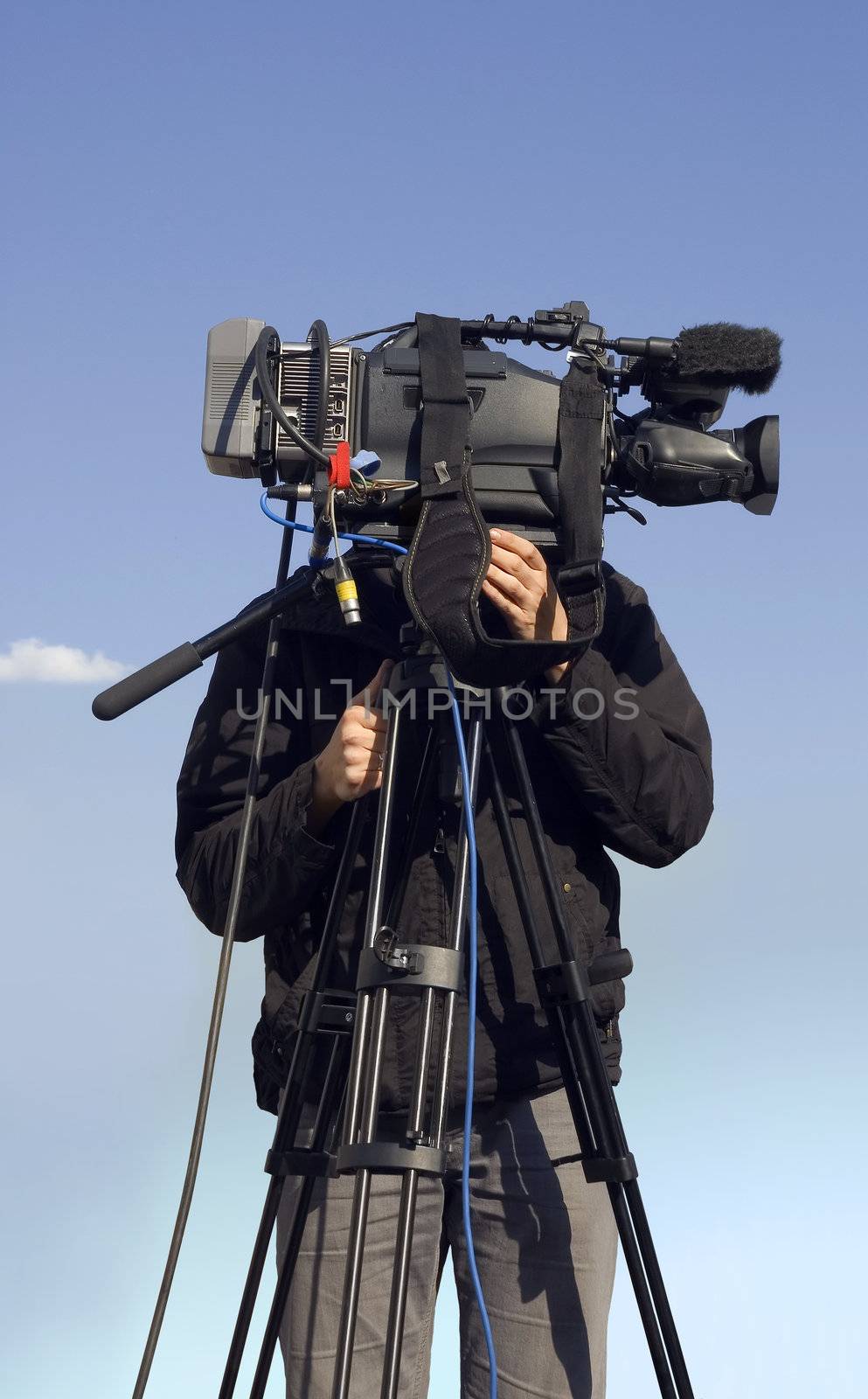 Camera operator on blue sky background