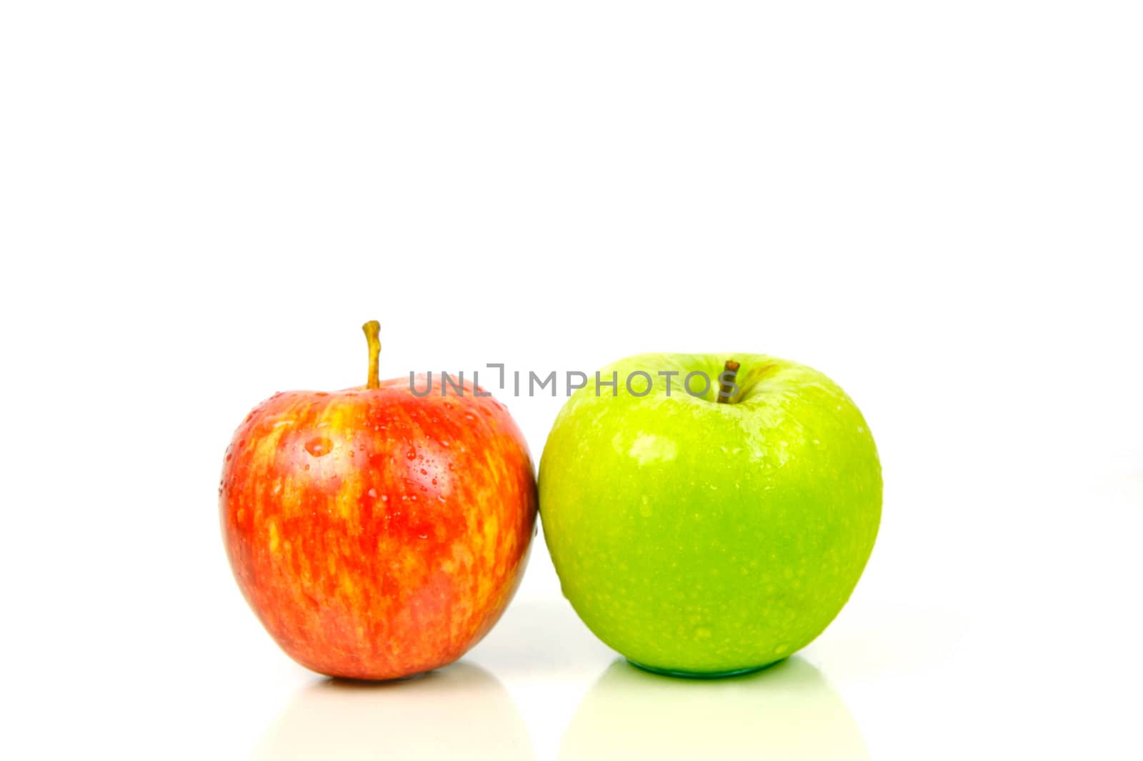 Red and green apples isolated against a white background