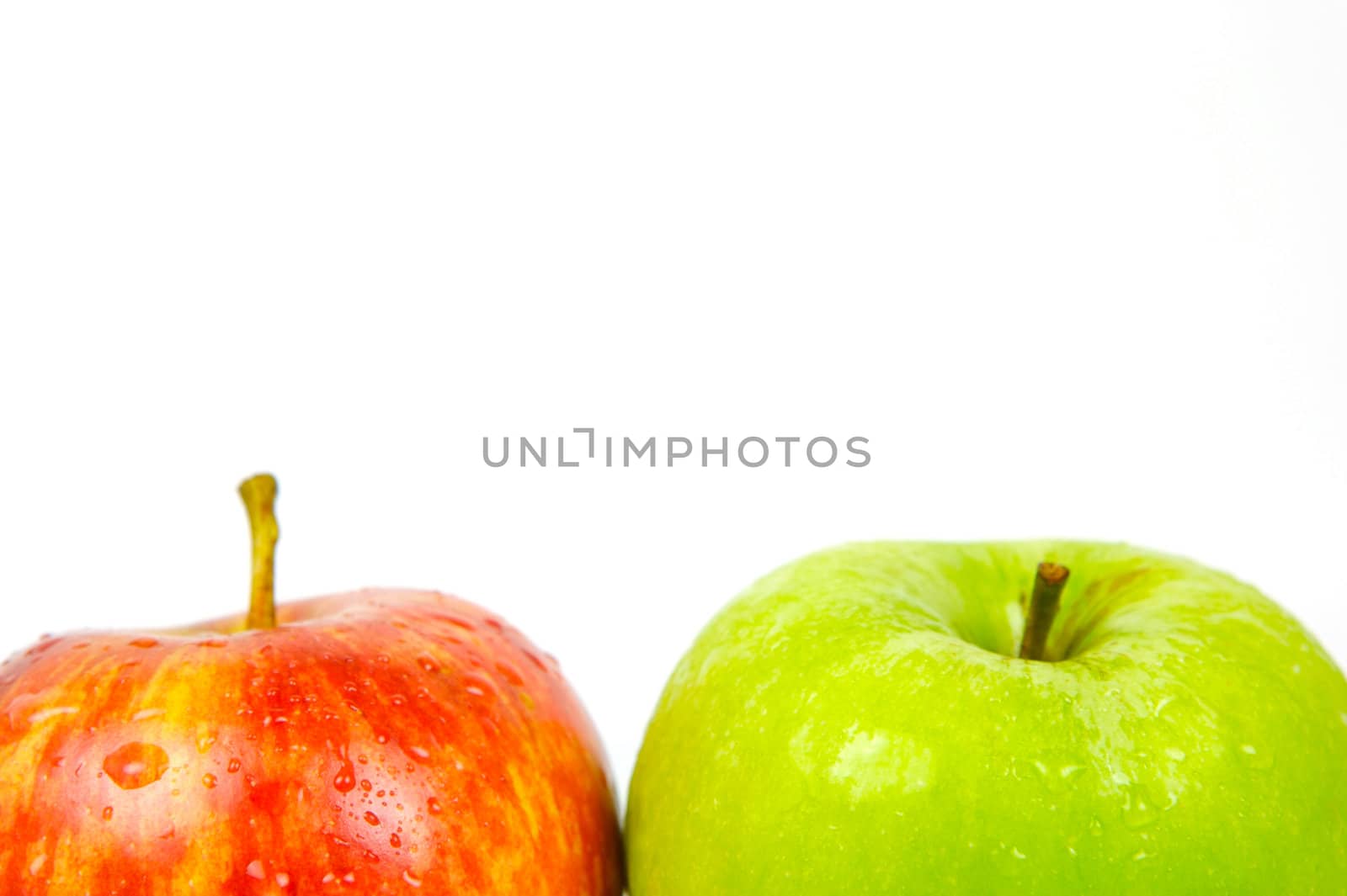 Red and green apples isolated against a white background