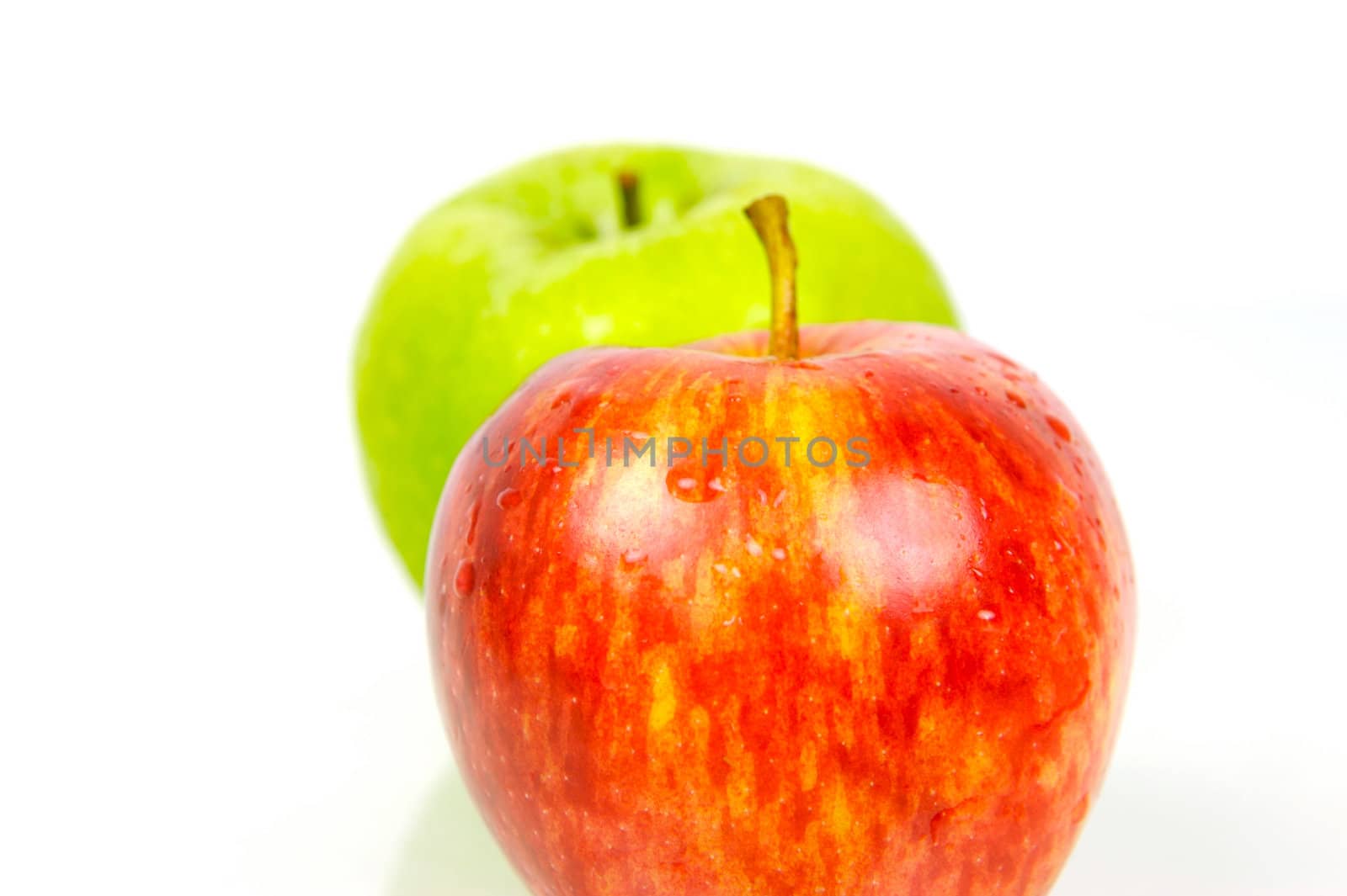 Red and green apples isolated against a white background