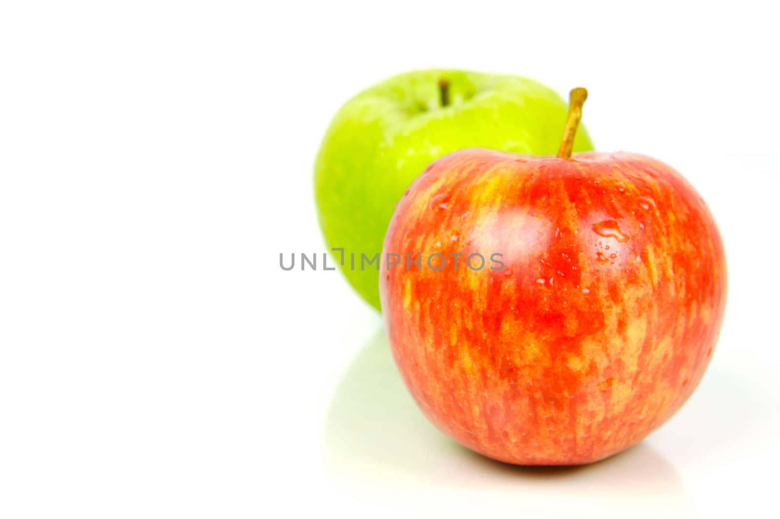 Red and green apples isolated against a white background