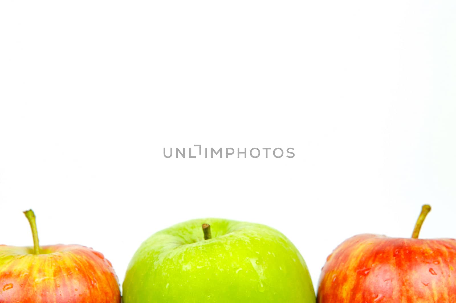 Red and green apples isolated against a white background