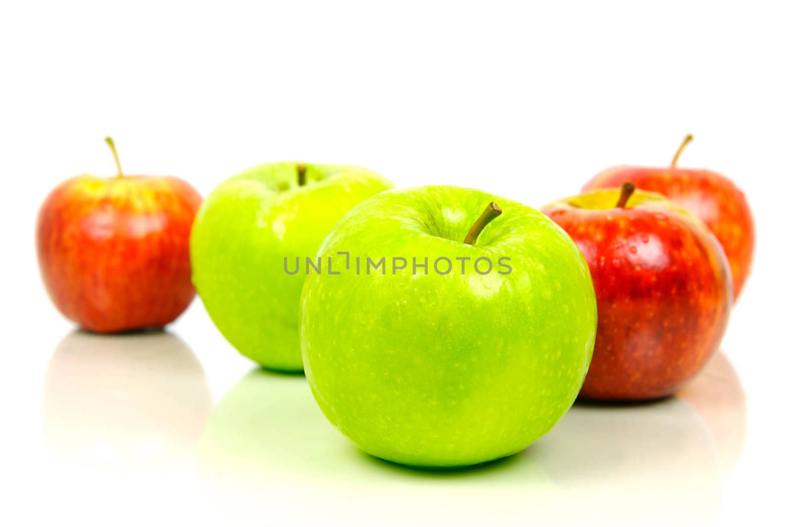 Red and green apples isolated against a white background