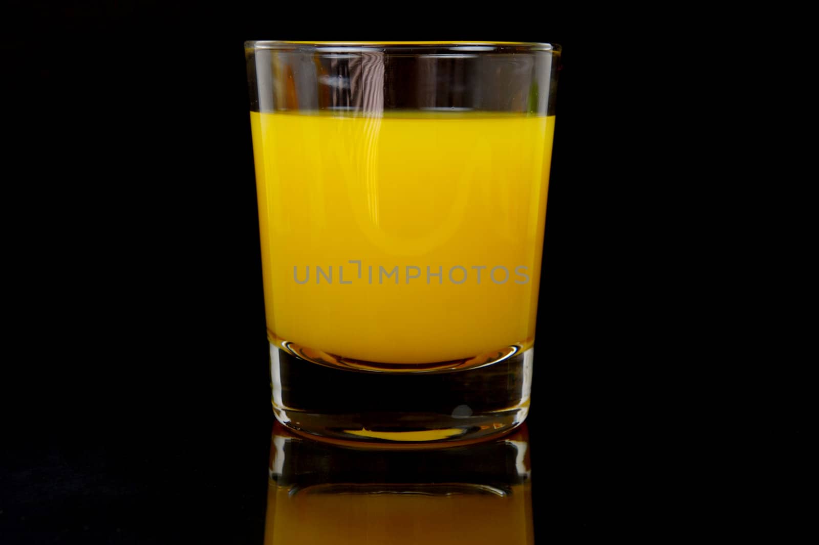 Orange juice isolated against a black background