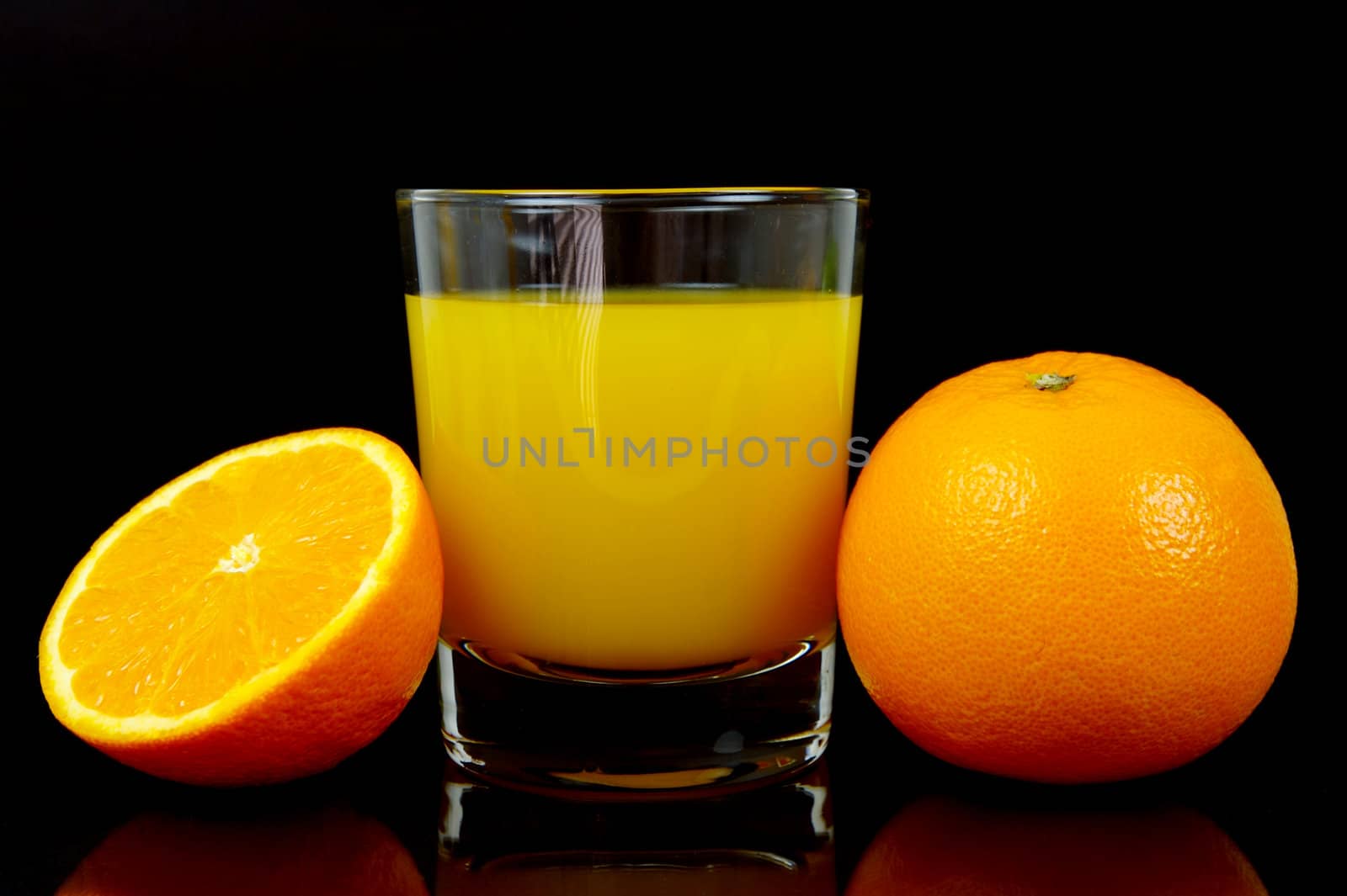 Orange juice isolated against a black background