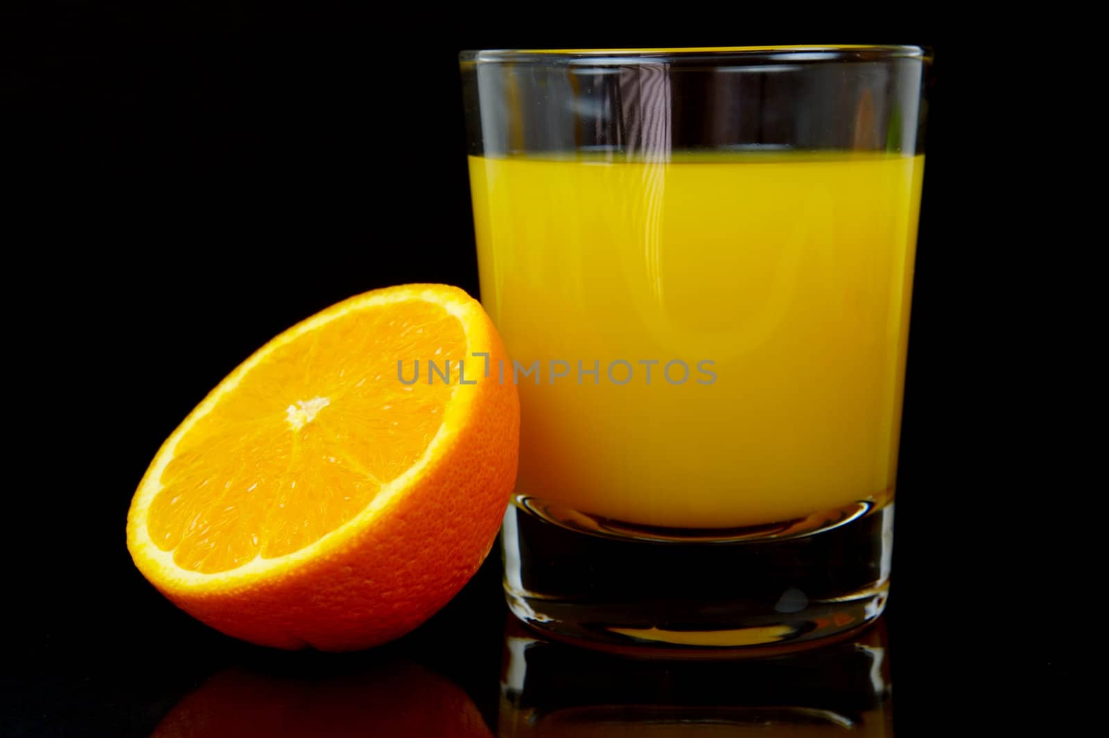 Orange juice isolated against a black background