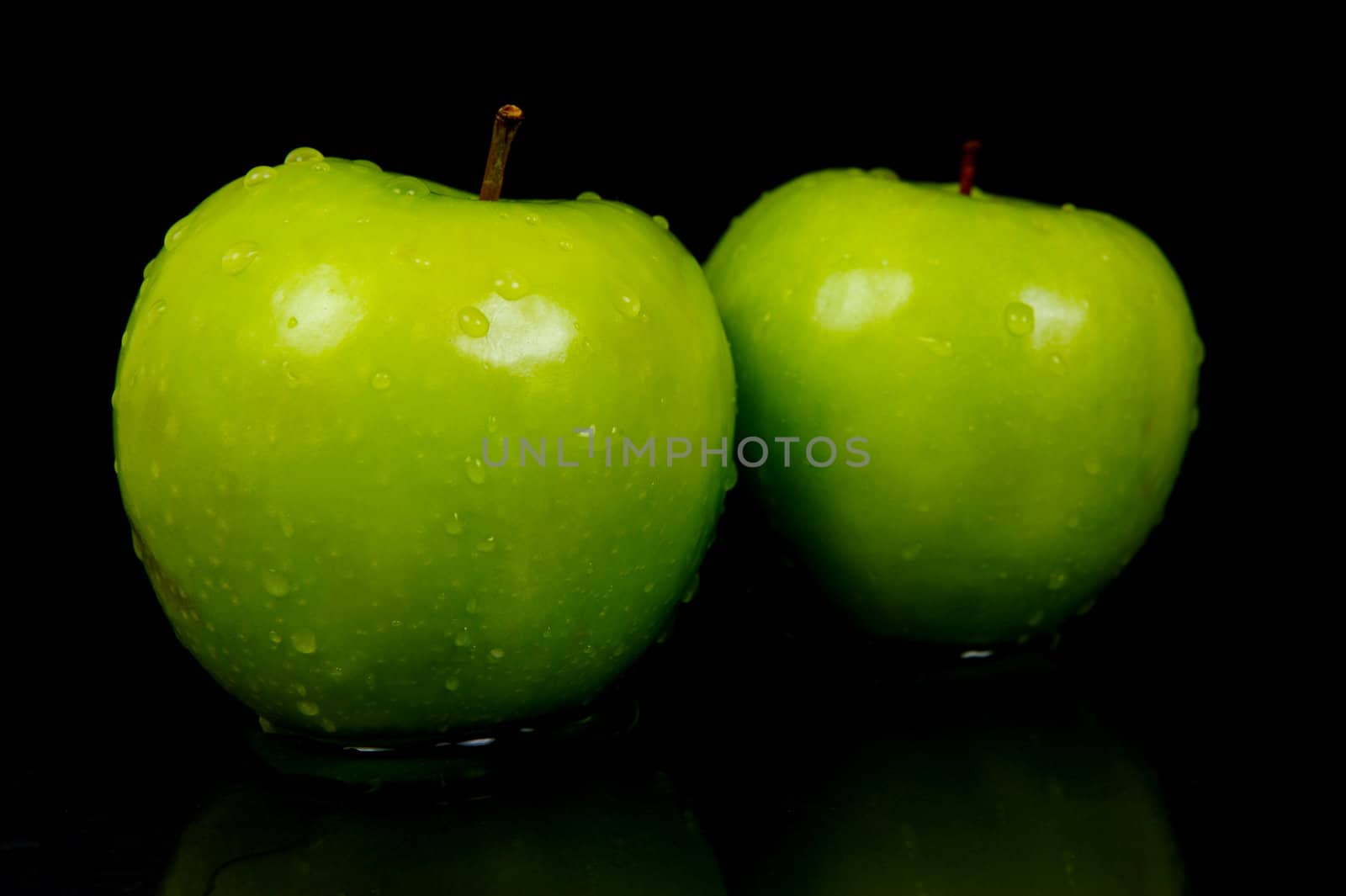 Green Apples isolated against a black background