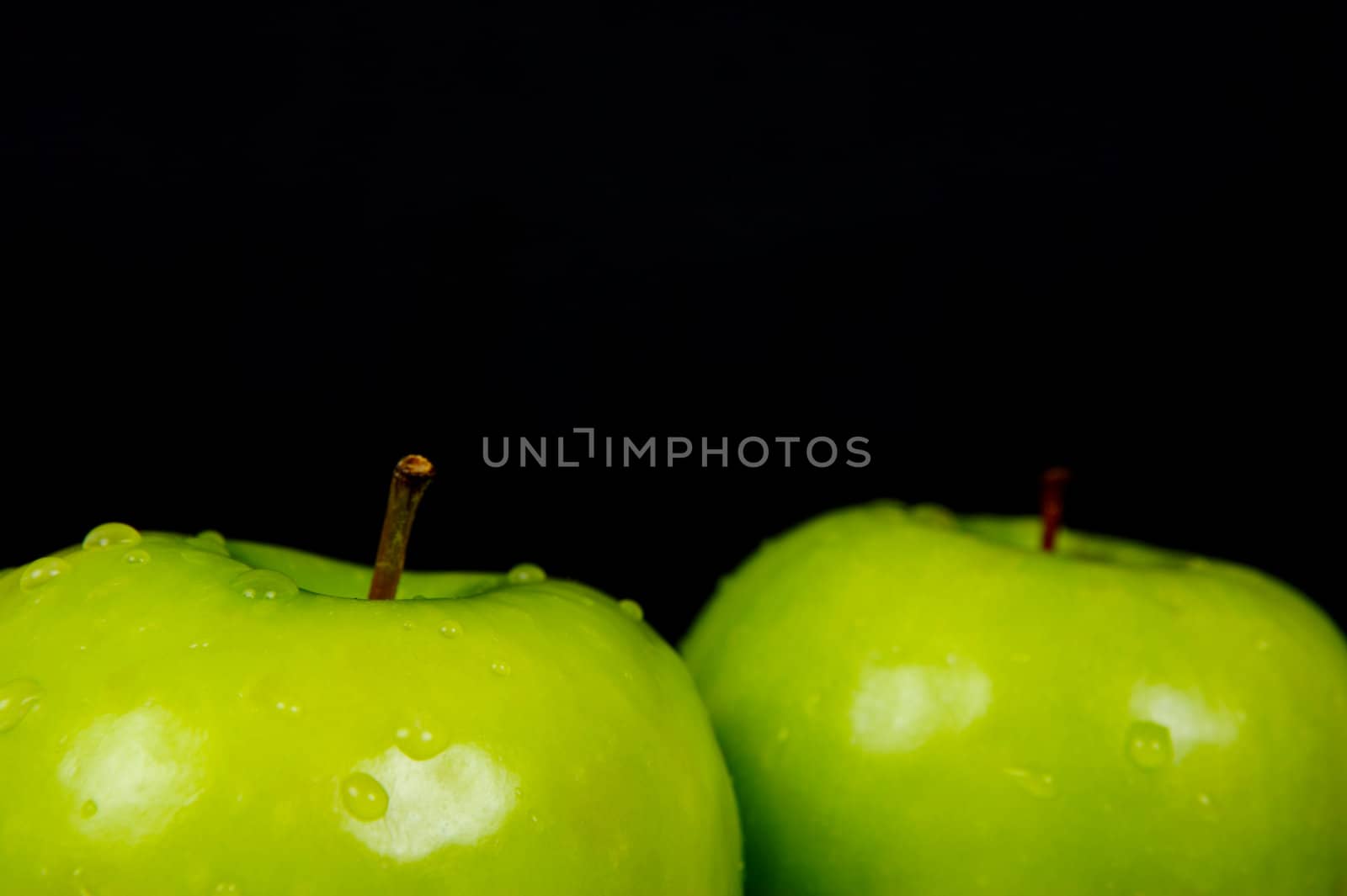 Green Apples isolated against a black background