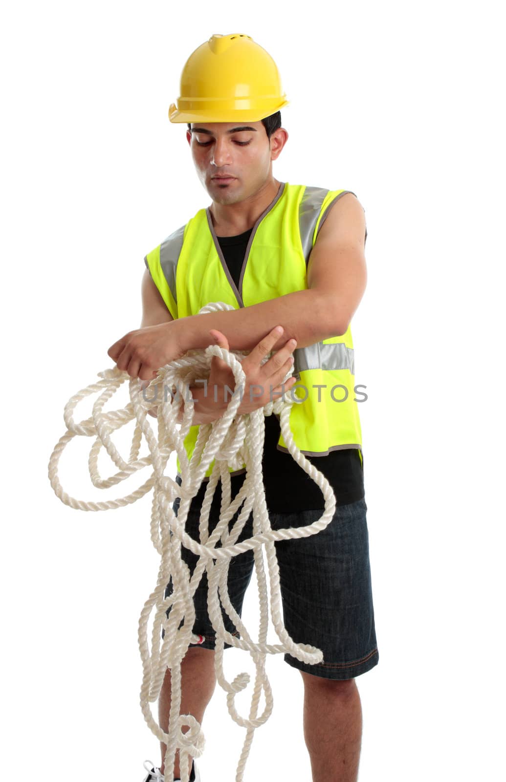 Builder, construction worker or shipbuilder or other tradesman gathering rope. White background.