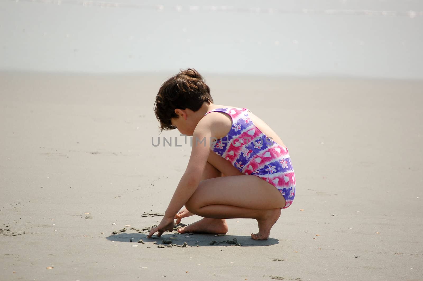 Girl Drawing On The Beach