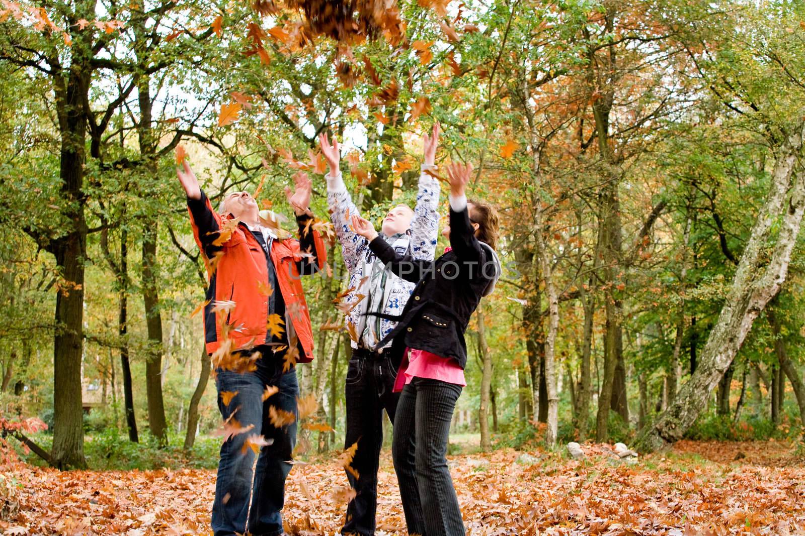 Happy young family in the autumn forest