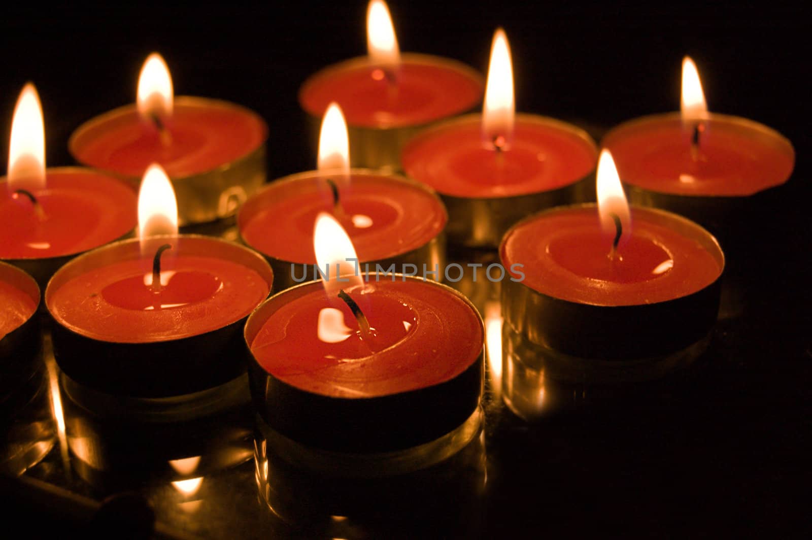 lit candles on black background