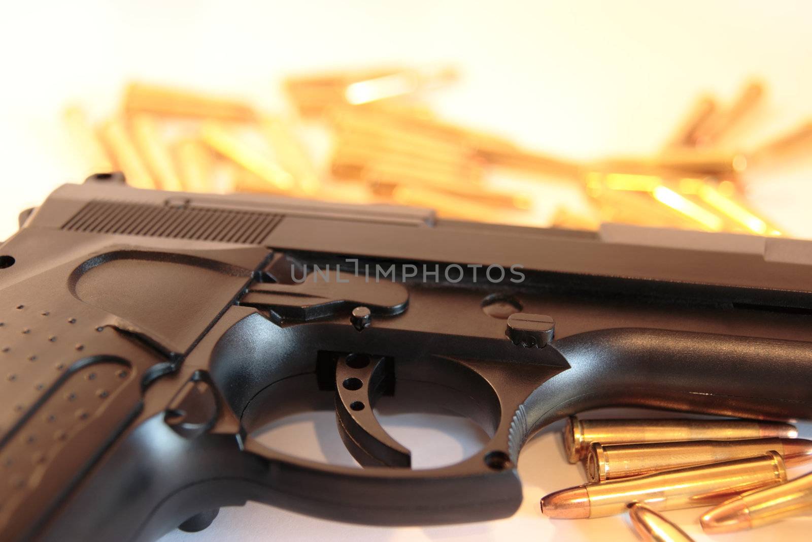 gold ammo and a handgun depicting gun culture