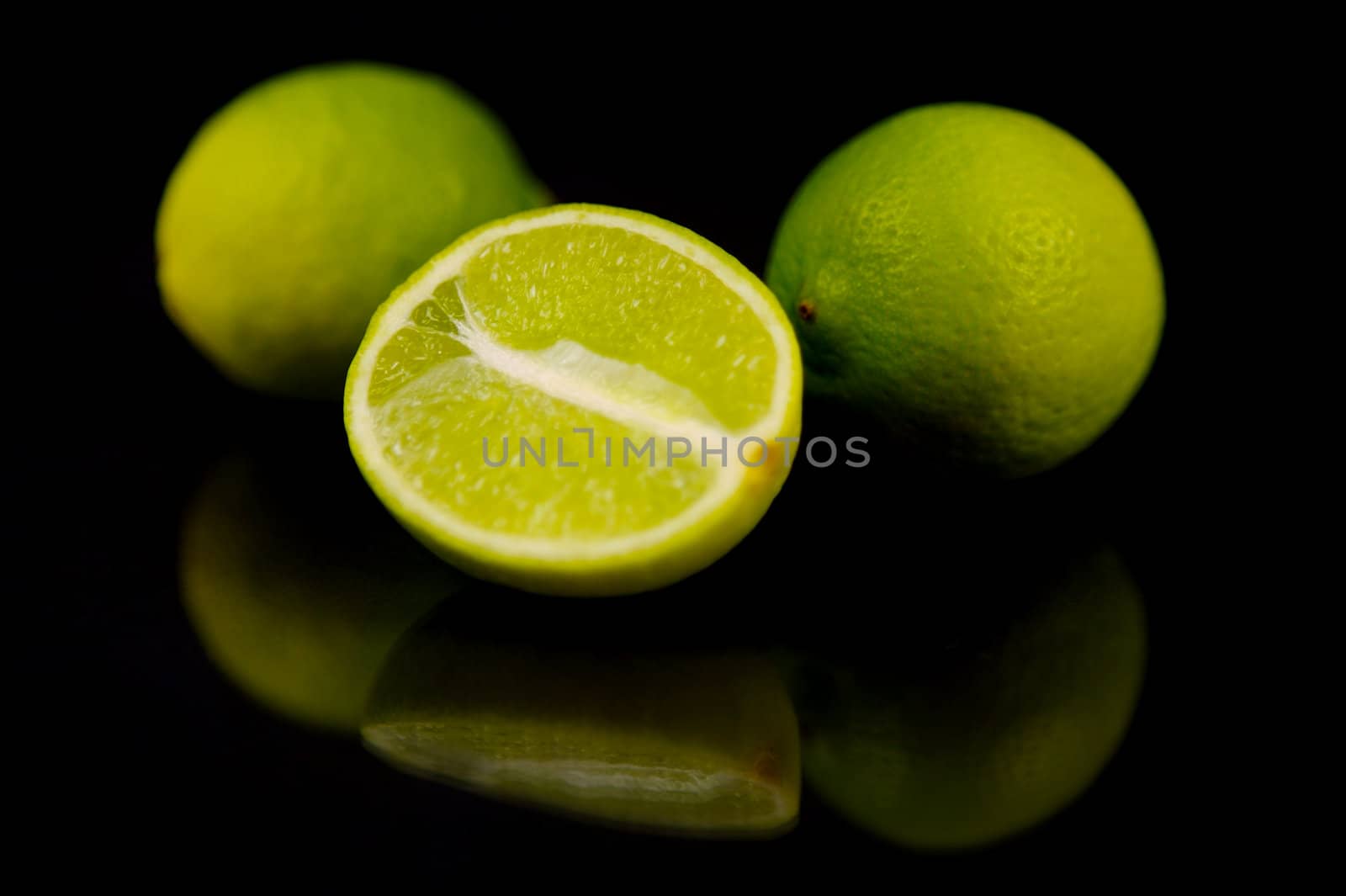 Lime citrus fruits isolated against a black background