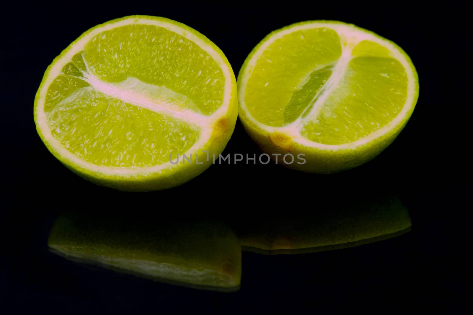 Lime citrus fruits isolated against a black background