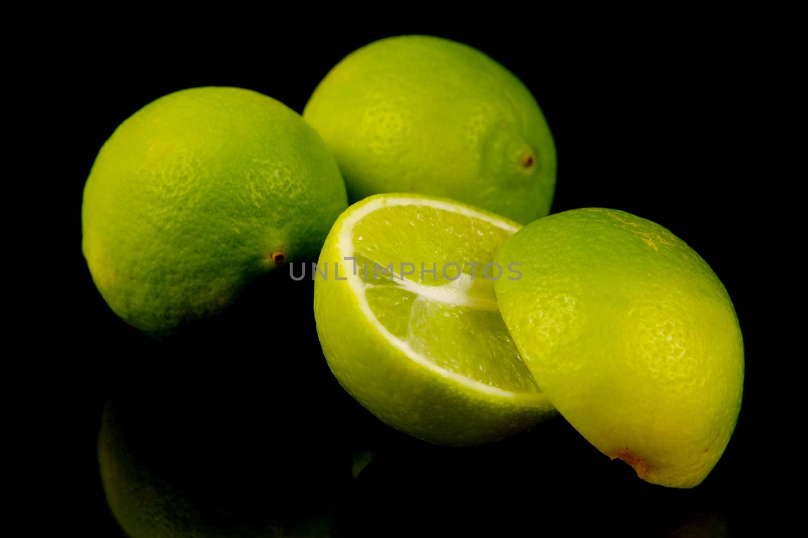 Lime citrus fruits isolated against a black background