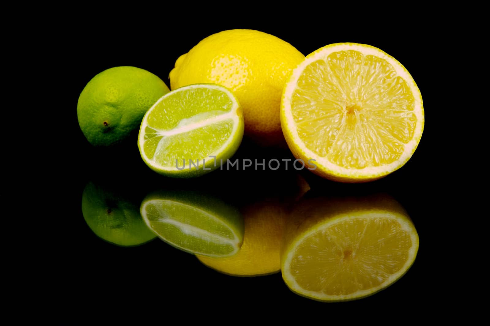 Lemon and lime citrus fruits isolated against a black background