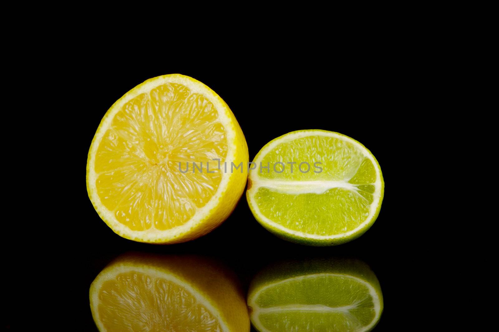 Lemon and lime citrus fruits isolated against a black background