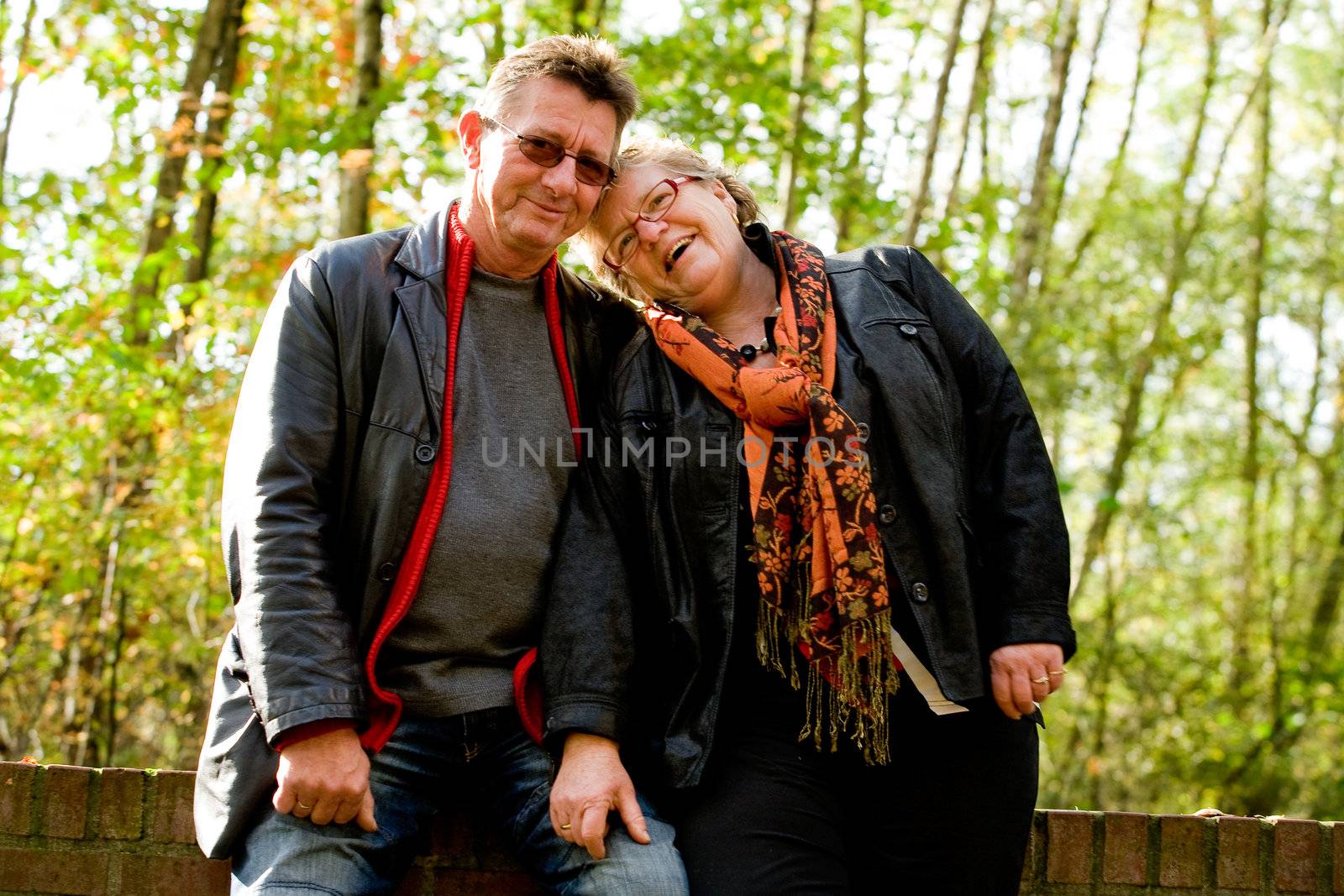 Happy older couple in the autumn forest