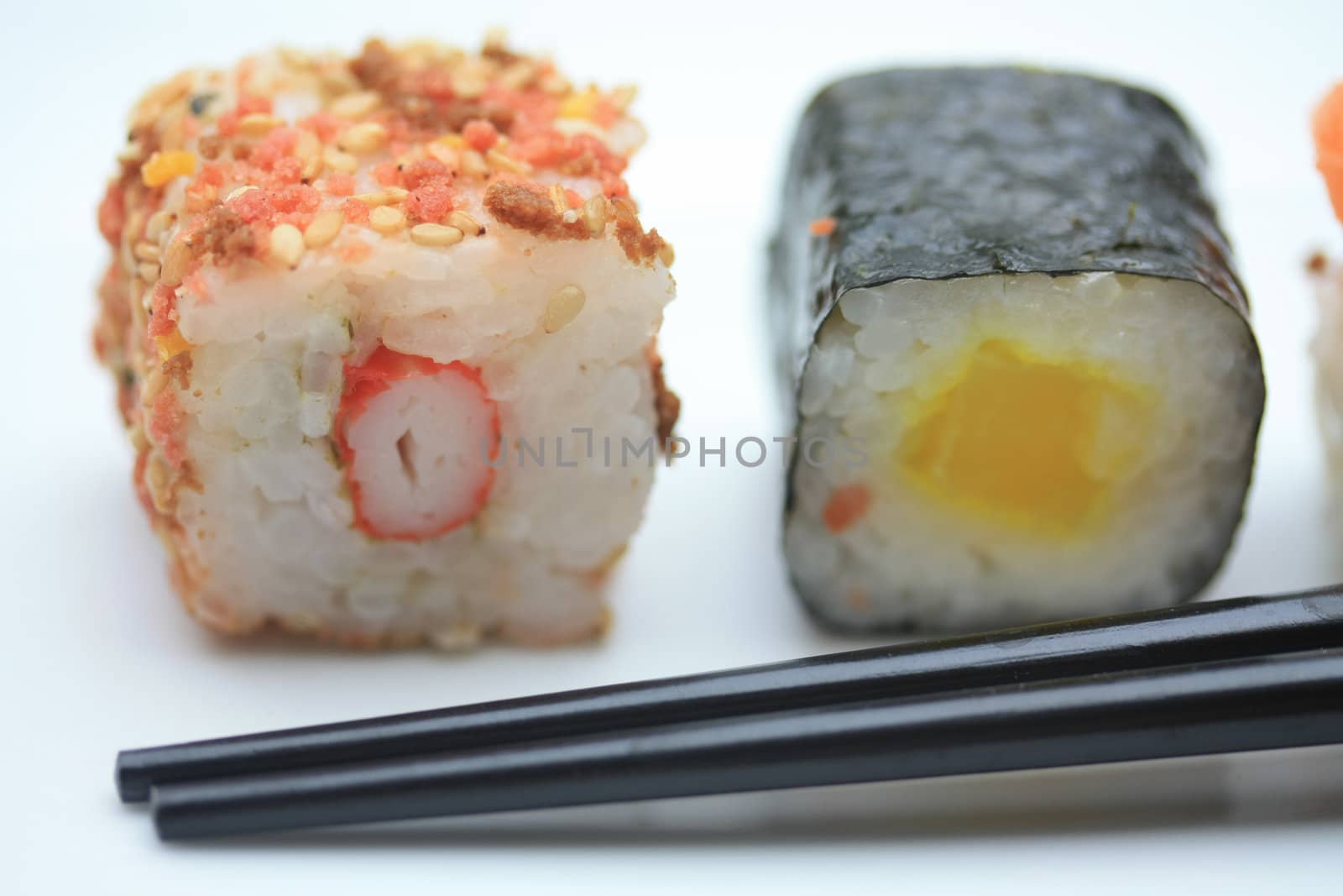 Two pieces of sushi� sesame and rice and a traditional Makisushi, made from rice rolled in seaweed called Nori