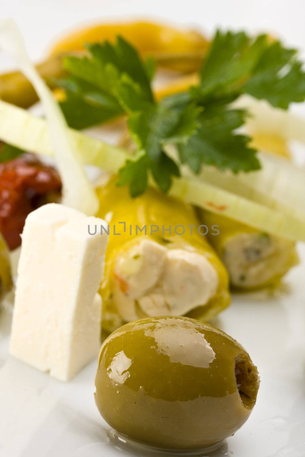 white plate with antipasti - olives, tomatos and peperoni
