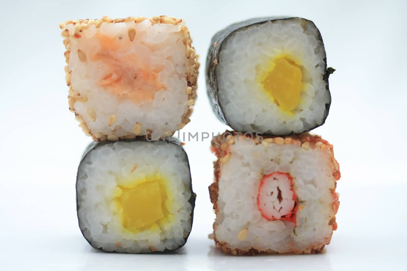 Different sorts of sushi, stacked on top of eachother
