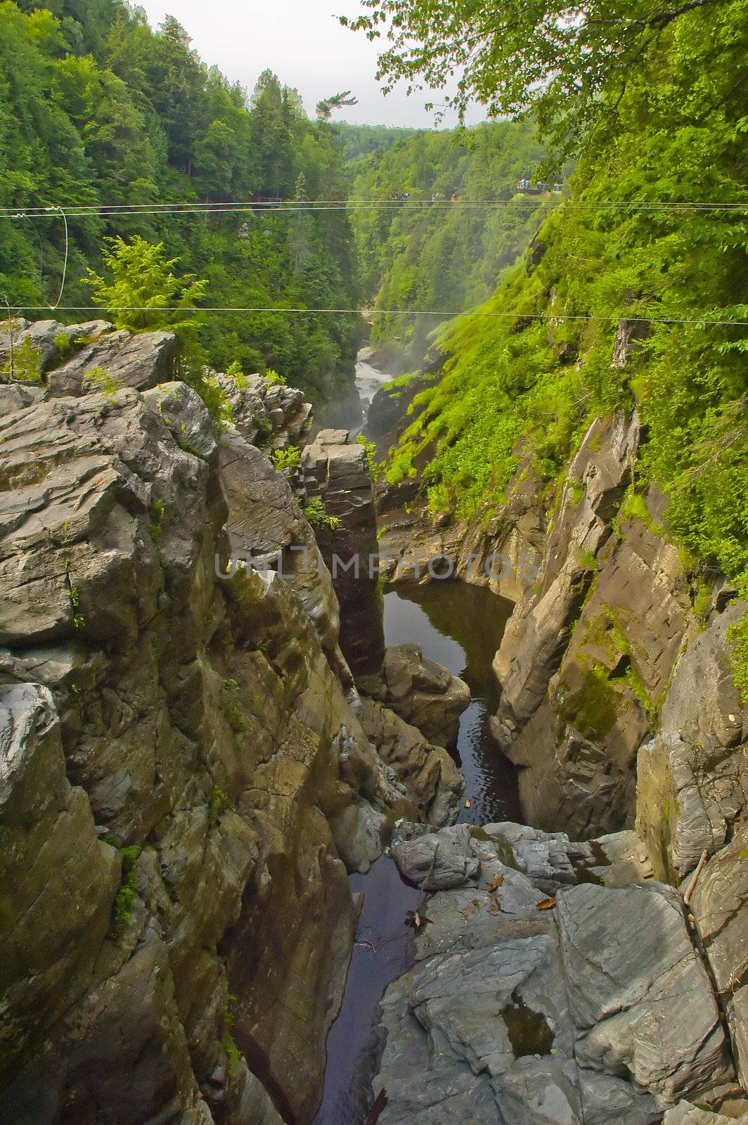 a small river flowing in the middle of a canyon