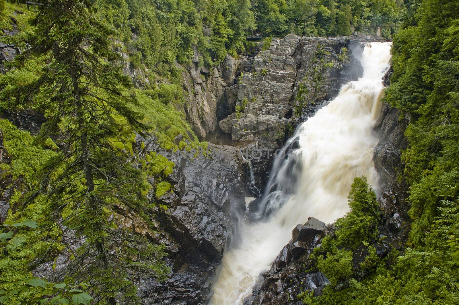 a big waterfall falling down to a canyon