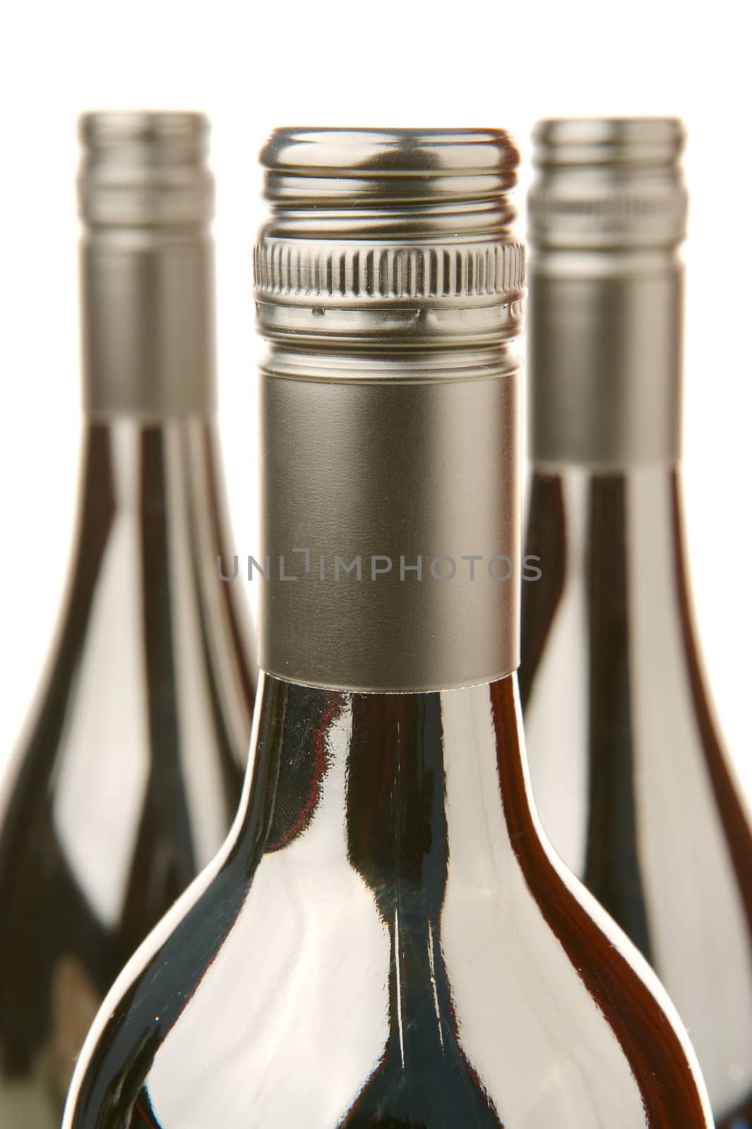 Bottles of red wine isolated against a white background