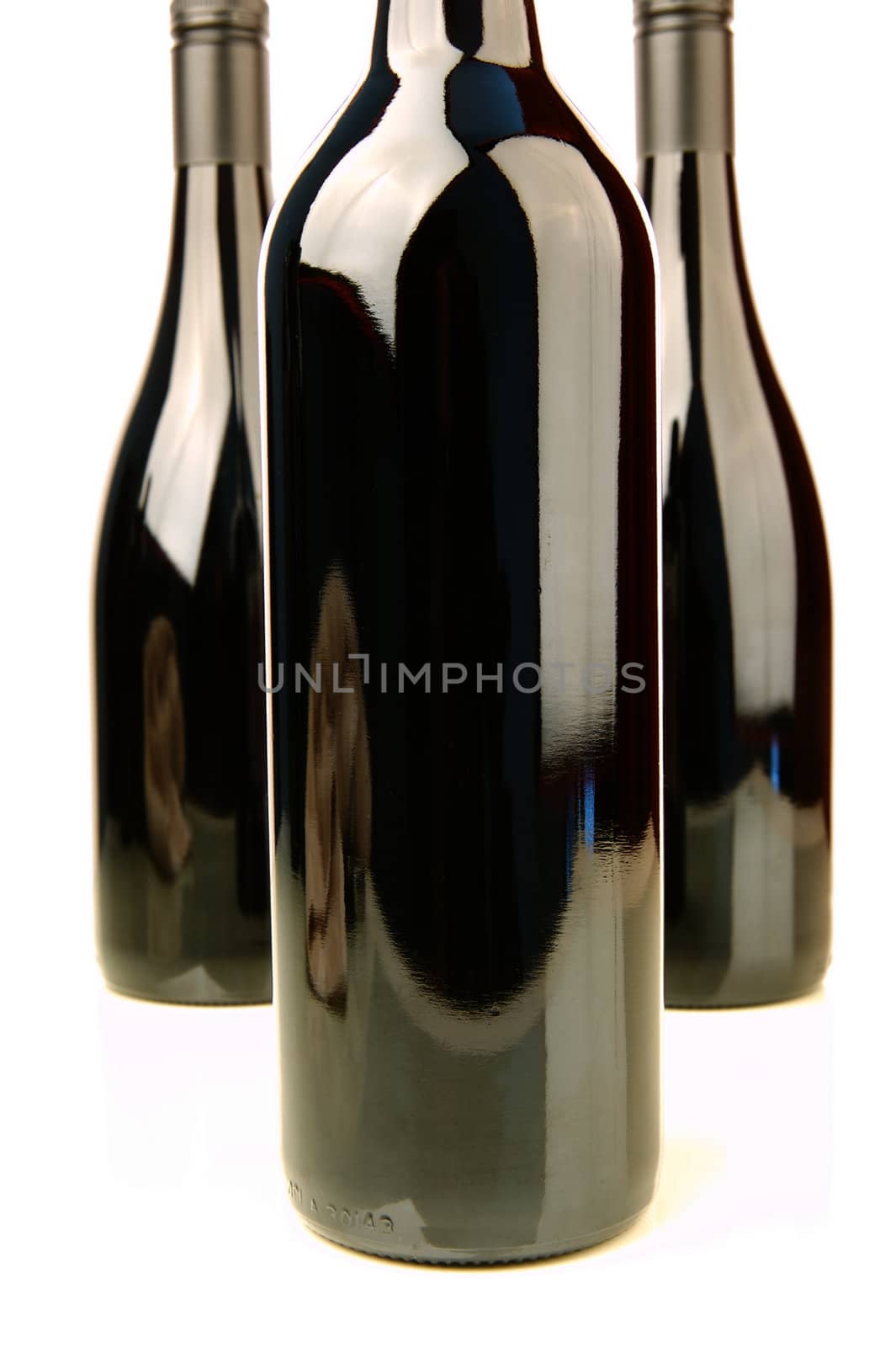 Bottles of red wine isolated against a white background