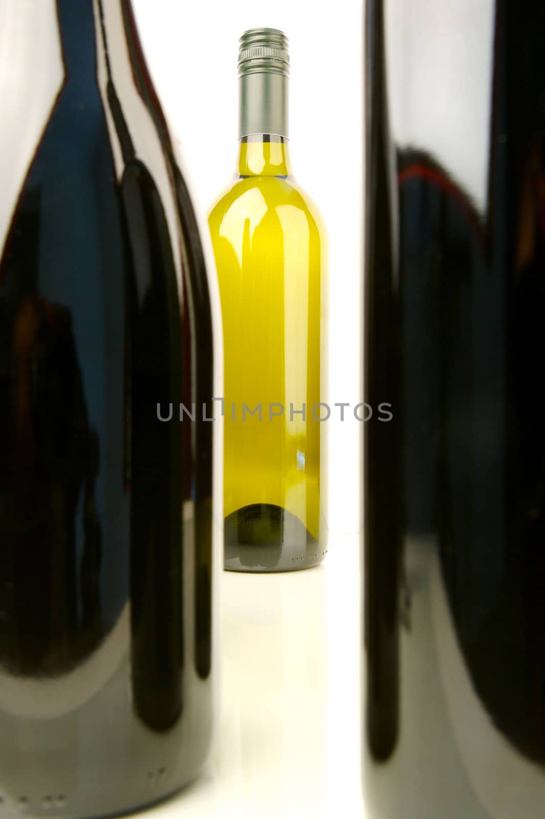 Bottles of red and white wine isolated against a white background