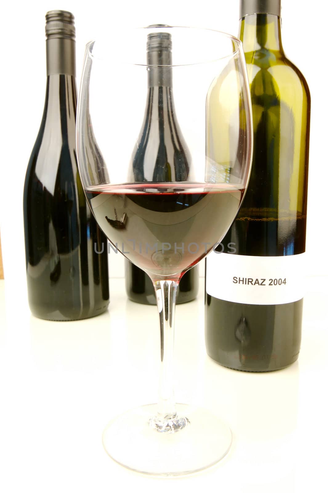 Red and white wine isolated against a white background