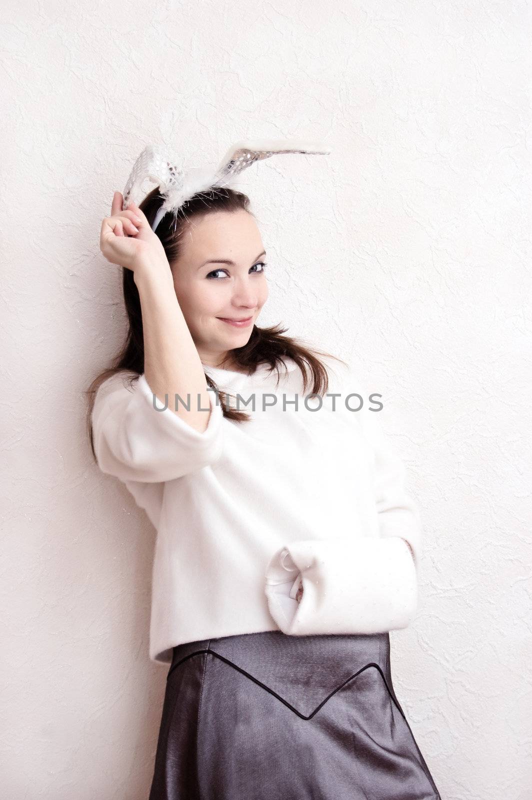 lovely woman in fluffy white coat and bunny ears