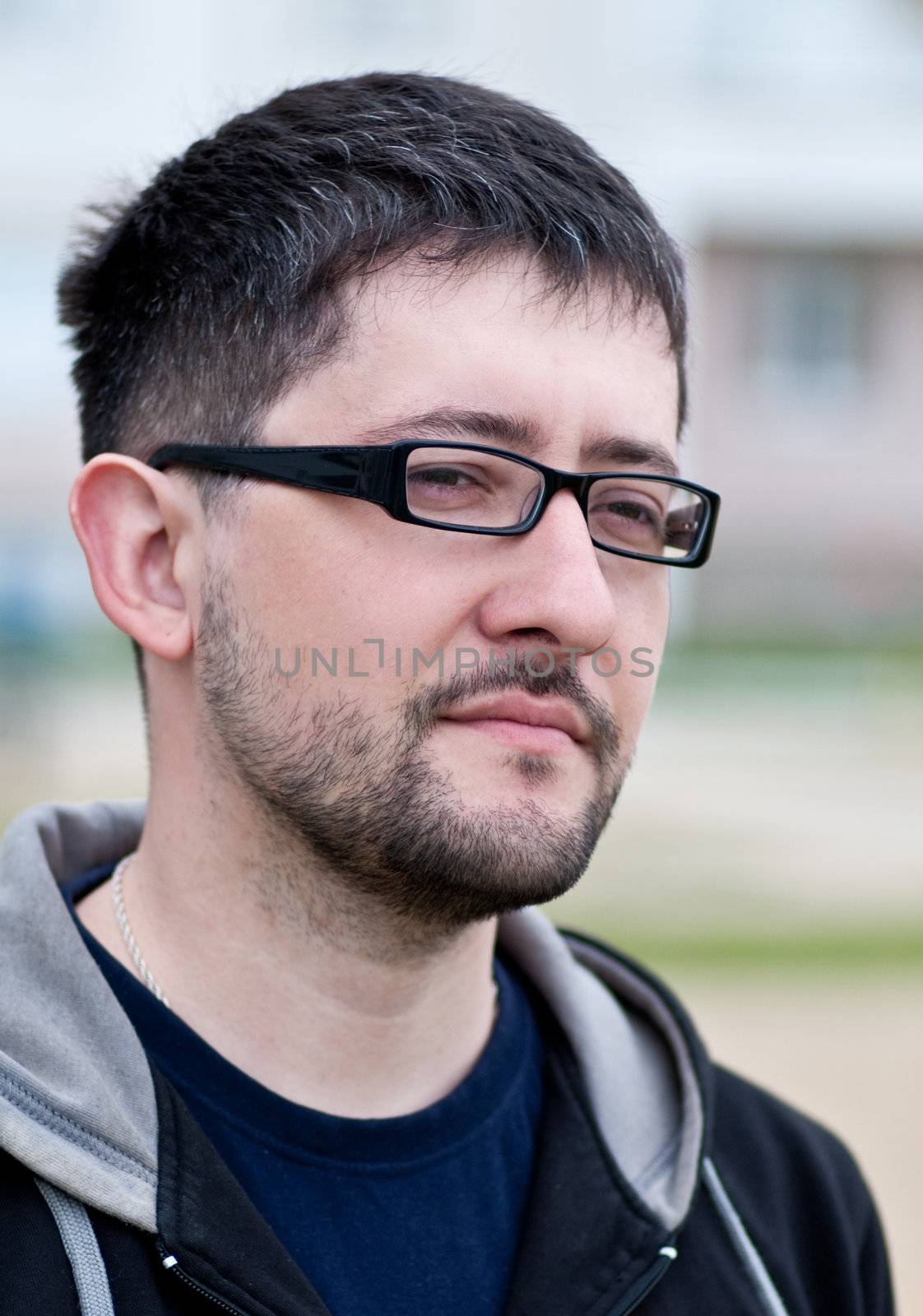 Portrait of a young bearded man wearing glasses by Shpinat