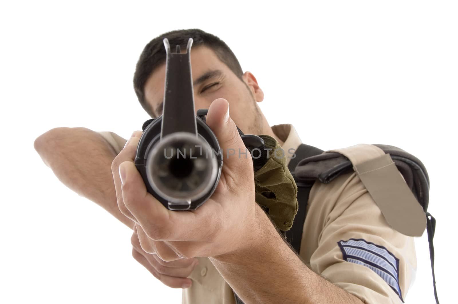 portrait of young soldier aiming against white background