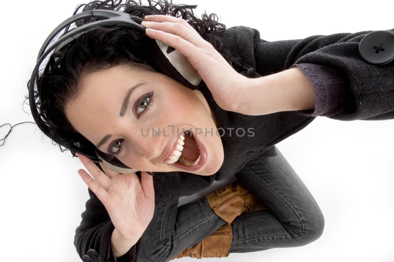 high angle view of smiling woman holding headphone with white background