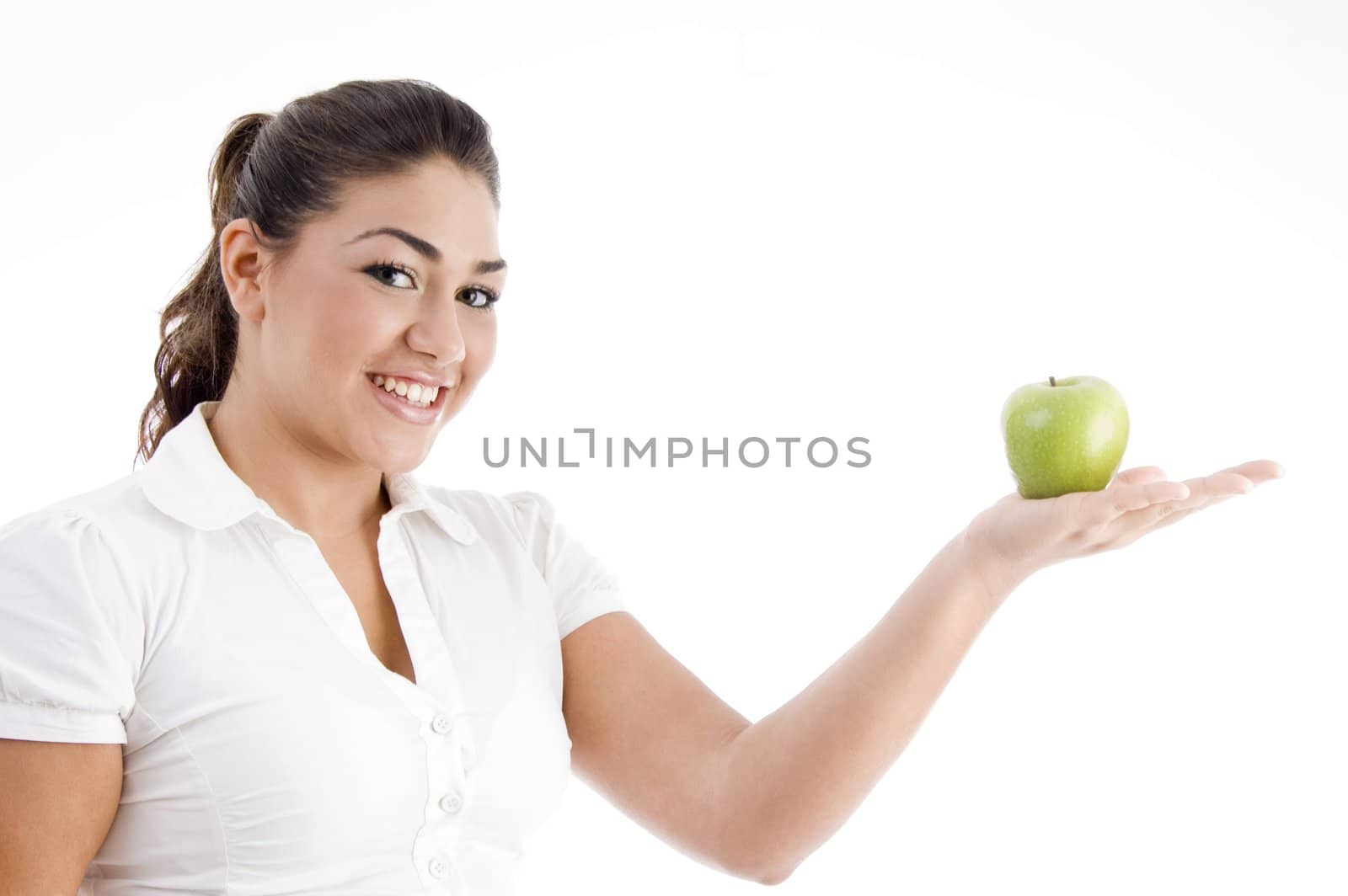 pretty young caucasian posing with an apple on her palm on an isolated background