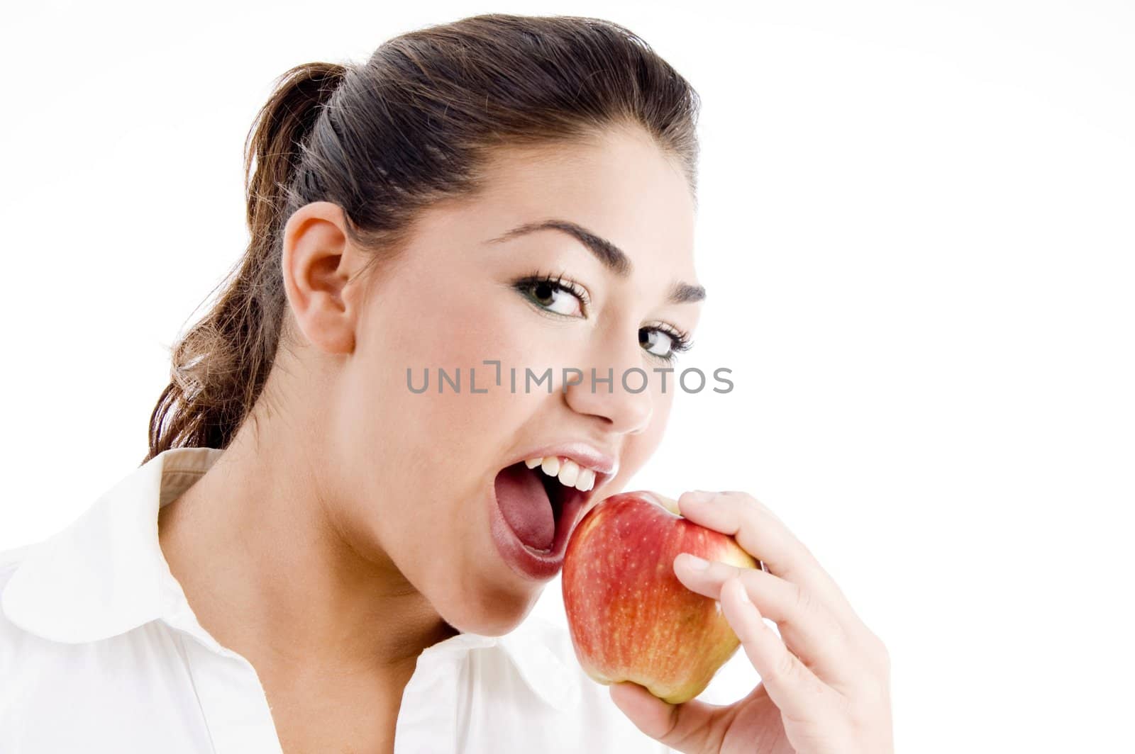 young american model eating an apple on an isolated background