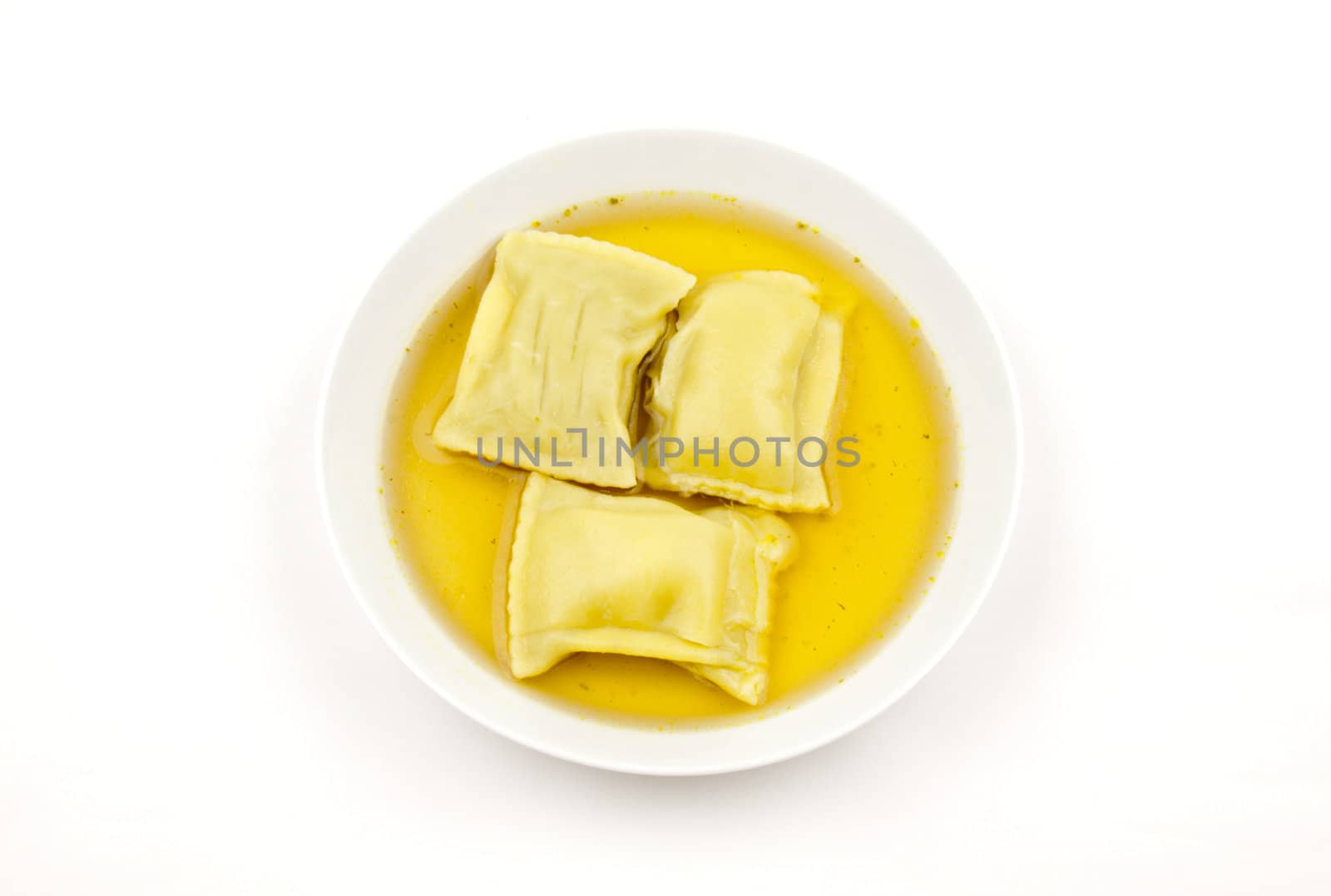 Pasta squares in clear soup, isolated on white background