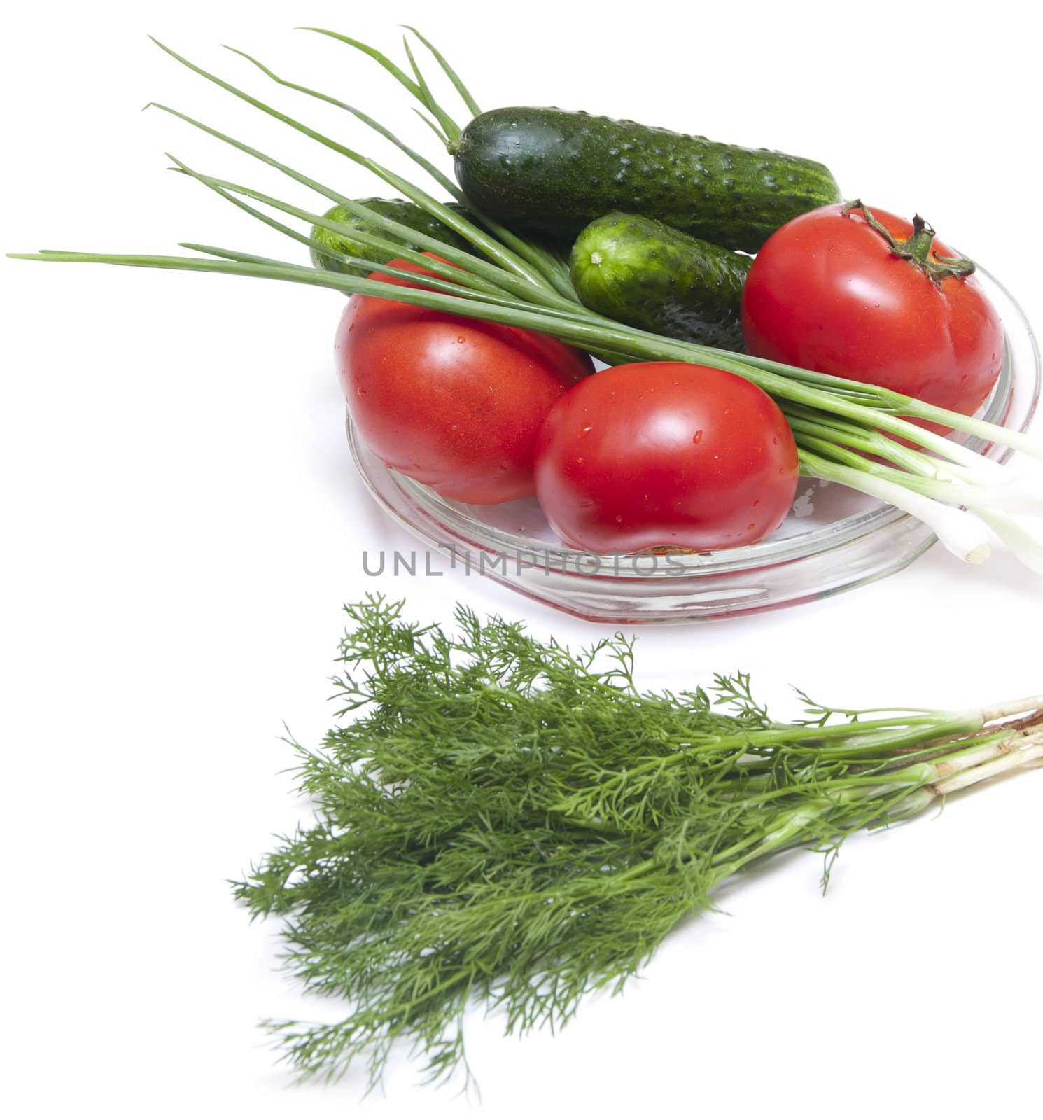 Cucumber, tomatoes, radish and greens, close up on wooden board 