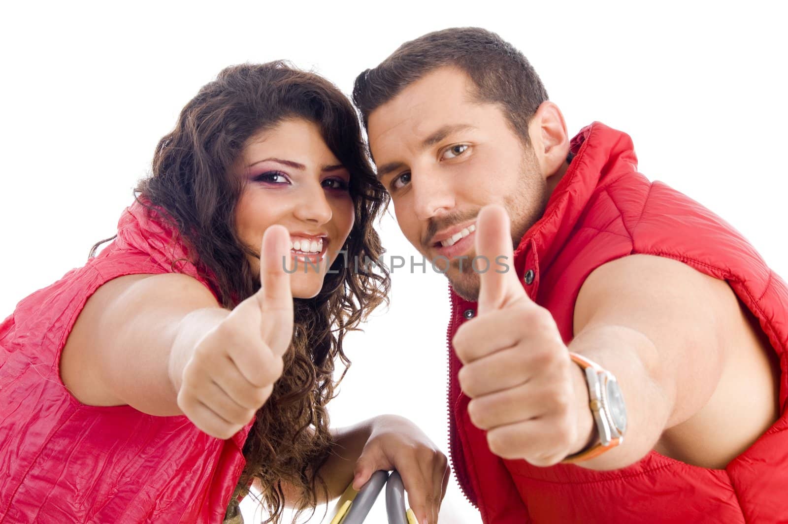 cheerful young couple showing thumbs up on an isolated white background