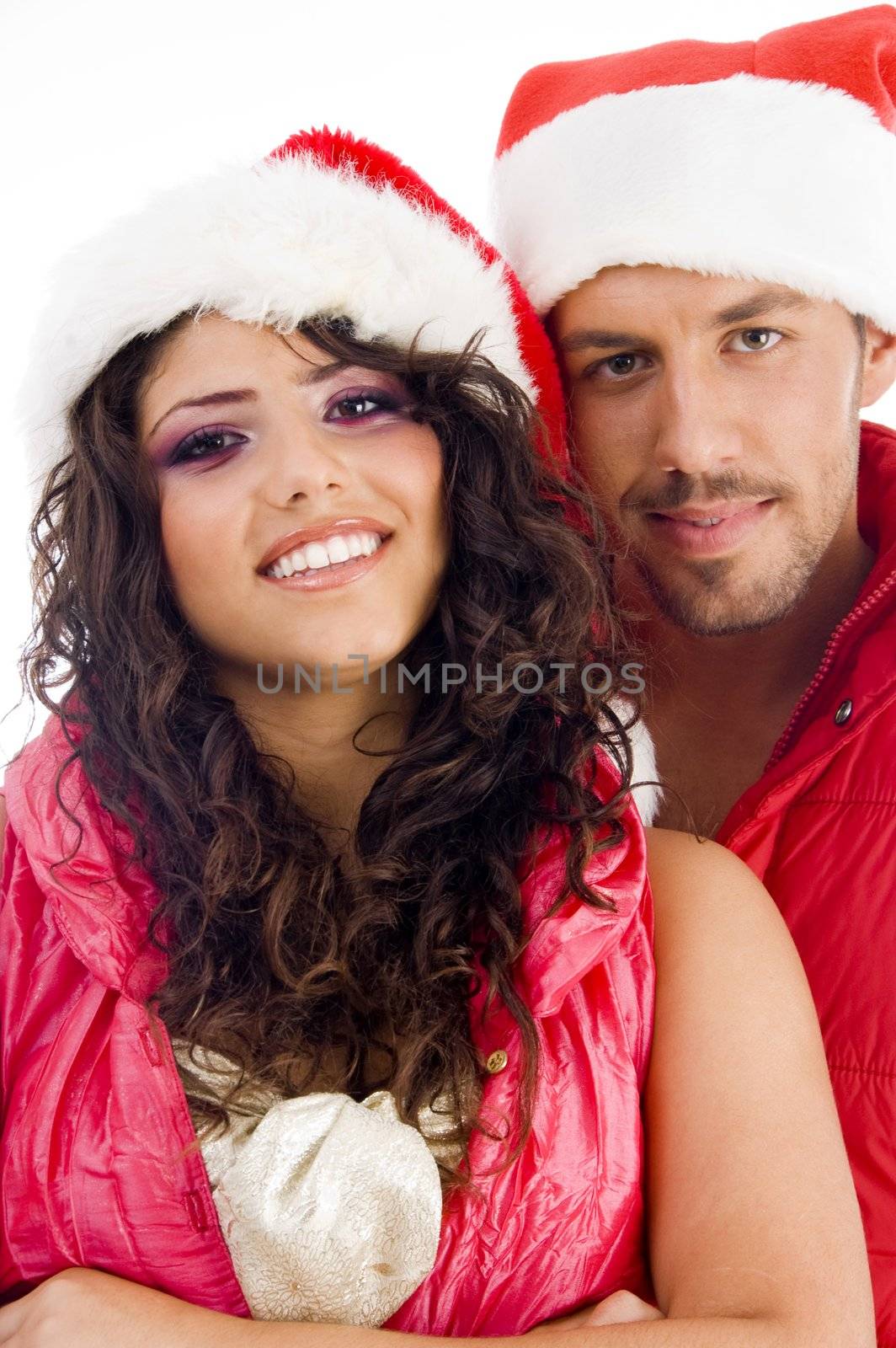 young amorous couple wearing christmas hat by imagerymajestic