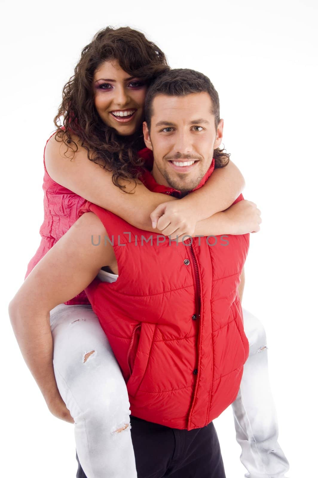 young male carrying woman piggyback against white background