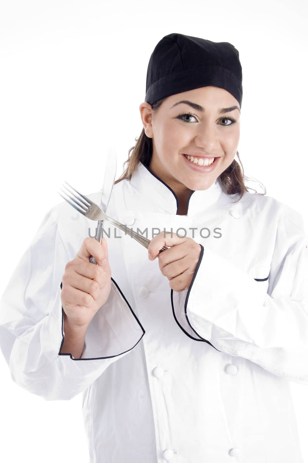 young chef holding metal cutlery with white background