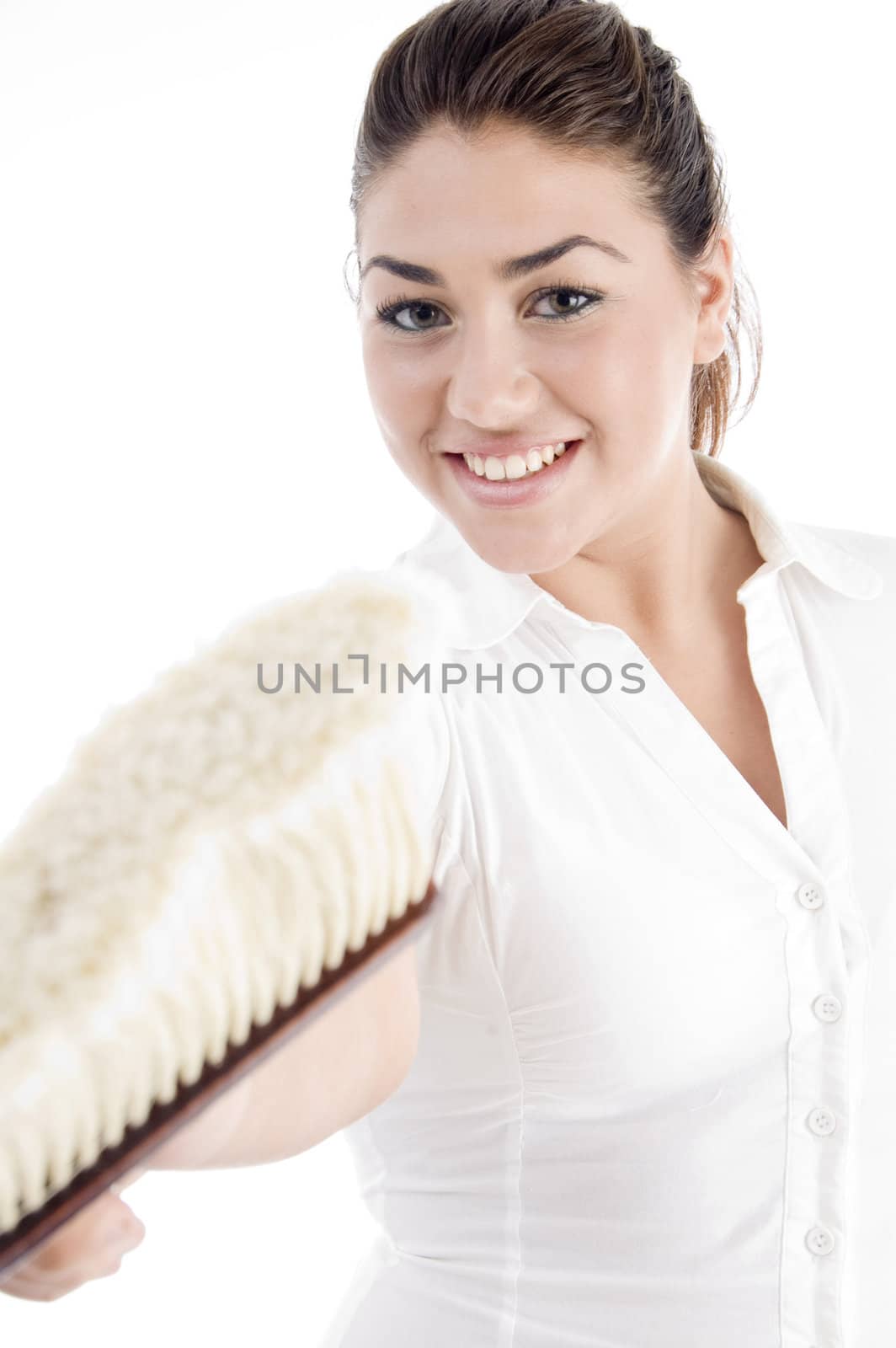 smiling girl holding cleaning brush against white background