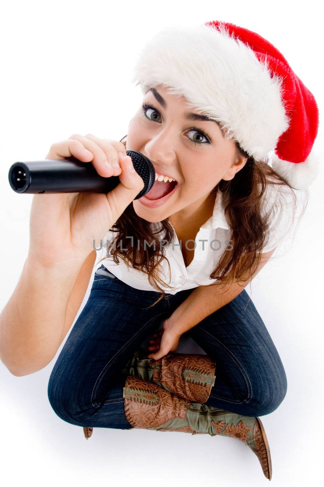 model holding karaoke and wearing christmas hat by imagerymajestic