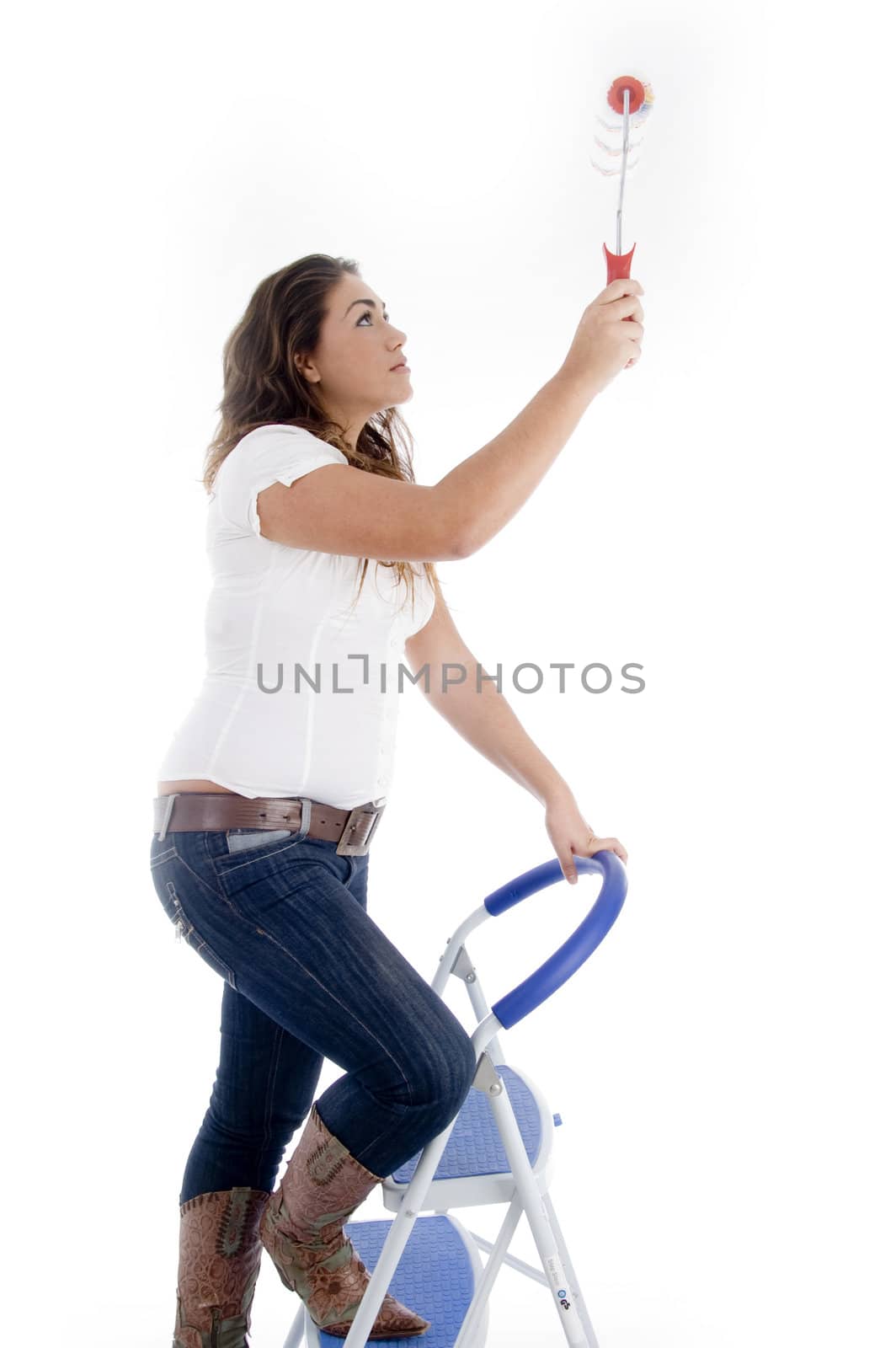woman standing on ladder chair and holding paint roller against white background